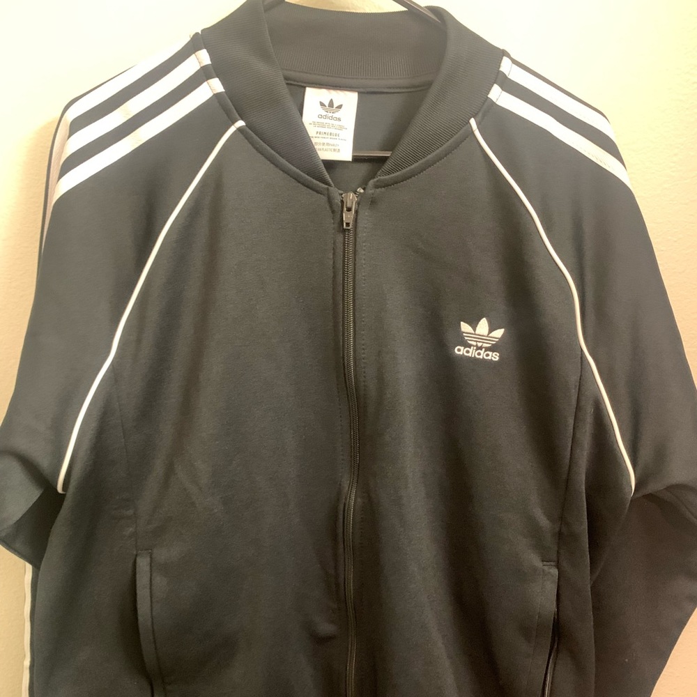 Black with white stripes Adidas track jacket.